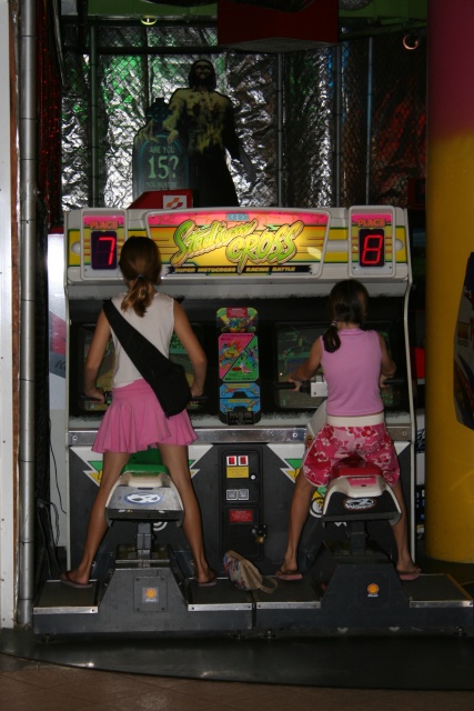 These two little girls were riding motorcycles in an arcade---COOL!